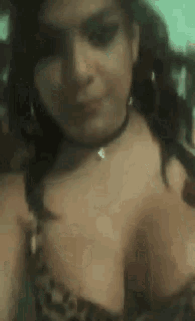 a close up of a woman 's breasts with a choker .