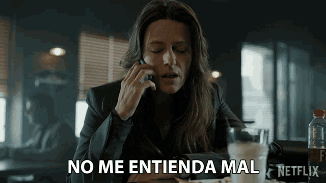 a woman talking on a cell phone with the words no me entienda mal written below her