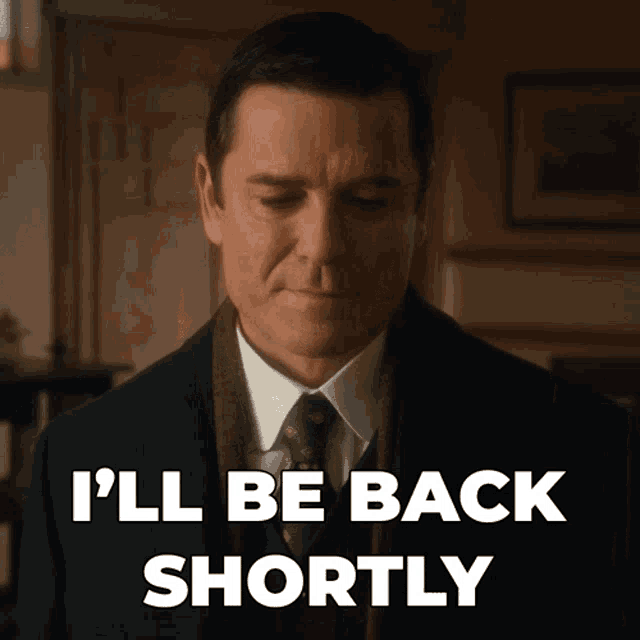 a man in a suit and tie with the words i 'll be back shortly below him