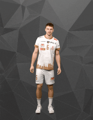 a man with his arms outstretched is wearing a white shirt with the number 5 on the front