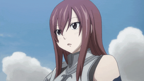 a girl with long red hair is wearing a silver shirt