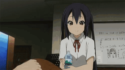 a girl holding a bottle of water in front of a white board