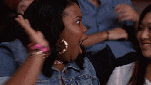 two women are giving each other a high five and smiling
