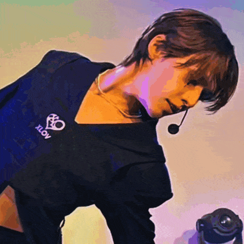 a woman wearing a black shirt with xlov written on it