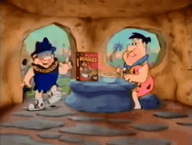 the flintstones are sitting at a table with a box of cereal