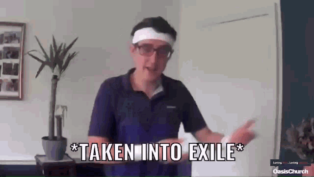a man wearing glasses and a headband with the words taken into exile