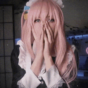 a woman with pink hair is wearing a maid outfit