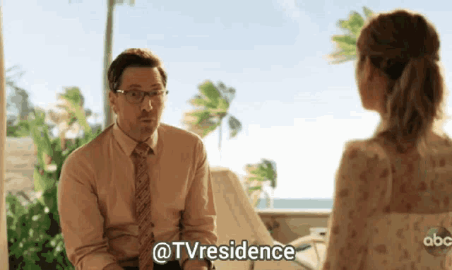 a man in a suit and tie is talking to a woman with the words @tvresidence written on the screen