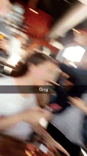 a blurry photo of a group of people with the word omg on the bottom right