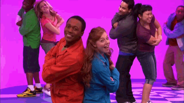 a group of people posing for a picture with their arms crossed and smiling