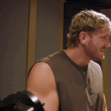 a man with a beard wearing a sleeveless shirt