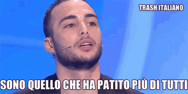 a man with a beard is wearing a microphone and says trash italiano on the bottom