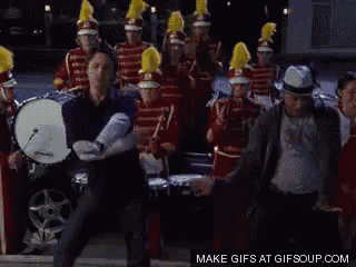 a man is dancing in front of a marching band with the words make gifs at gifsoup.com
