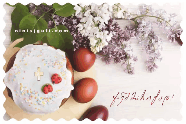 a cake with strawberries and a cross on it next to eggs and flowers with the website ninisjgufi.com