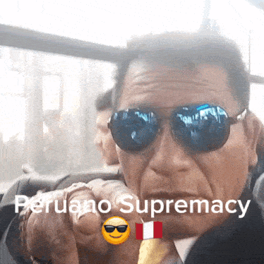 a man wearing sunglasses is pointing at the camera with the words peruano supremacy behind him