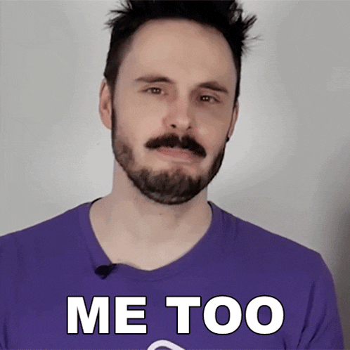 a man with a beard and mustache wearing a purple shirt that says me too