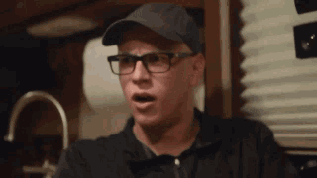a man wearing glasses and a hat with the word army on it