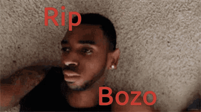 a man laying on the floor with the words rip bozo written above him