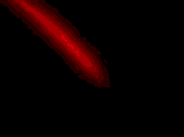 a red beam is shining on a black background .