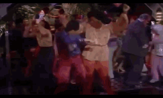 a group of people are dancing at a party in a club .