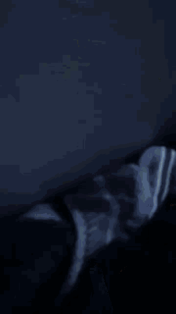 a blurred image of a person 's face with a blue sky behind them