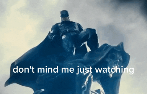 a statue of batman with the words " don 't mind me just watching " written below him