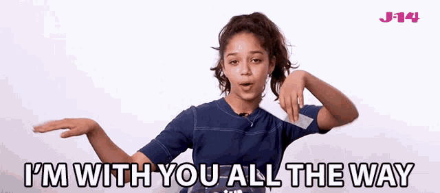 a girl says i 'm with you all the way while holding a piece of paper