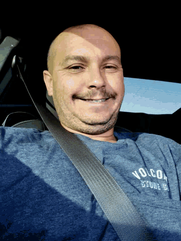 a man wearing a blue shirt that says volco