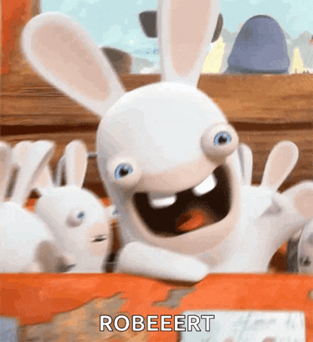 a rabbit from the video game rabbids is sitting on a table with its arms outstretched .