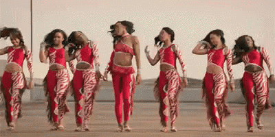 a group of women are dancing in red and white outfits