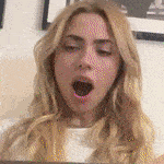 a close up of a woman with her mouth open .