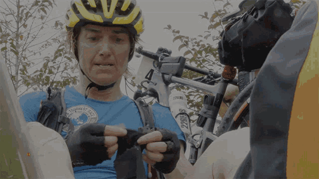 a man wearing a helmet and a blue shirt that says ' ridgeway race ' on it