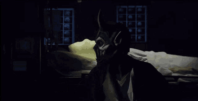 a person wearing a mask with horns on it