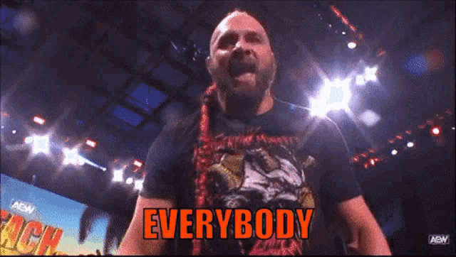a man in a wrestling ring with the words " everybody " above him