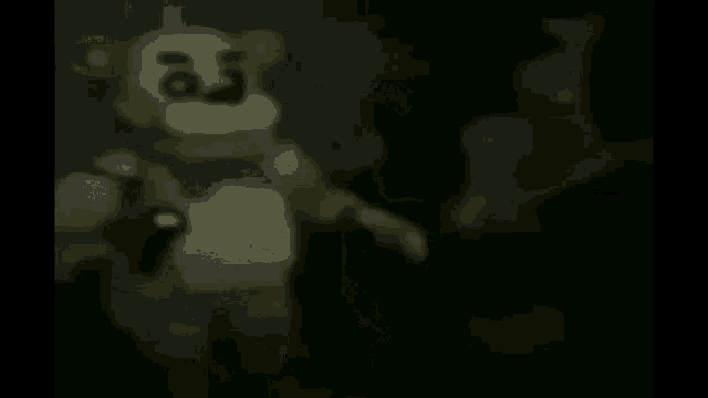a teddy bear is standing in the dark in a dark room with a shadow of a person behind it .