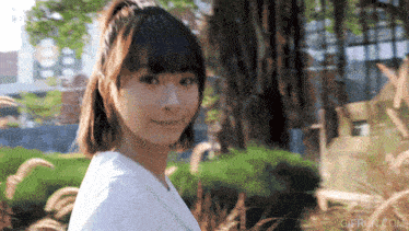 a gif from gifrun.com shows a woman in a white shirt smiling