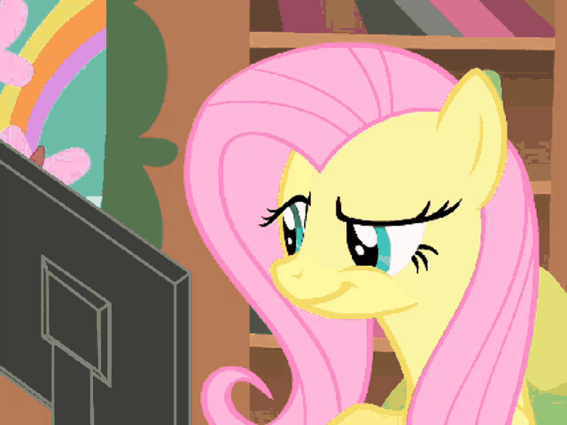a cartoon of a pony looking at a computer monitor