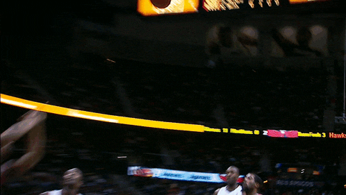 a basketball player is jumping in the air with the ball