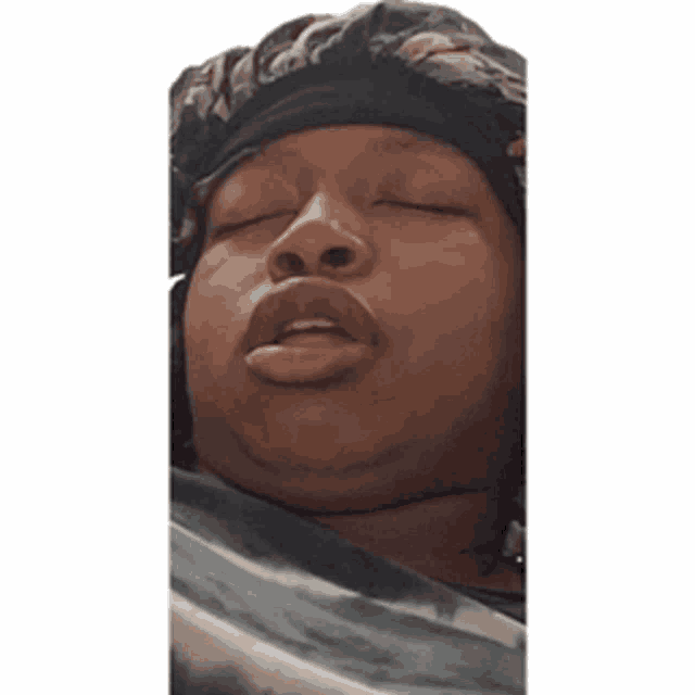 a woman with her eyes closed is wearing a headband