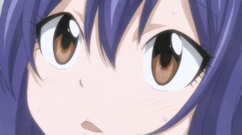 a close up of a girl 's eyes with a purple hair