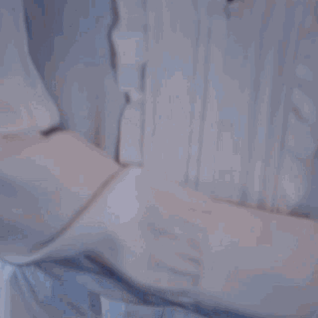 a close up of a person 's hand holding a piece of cloth .