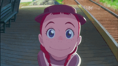 a girl with red hair and blue eyes is standing next to a railroad track
