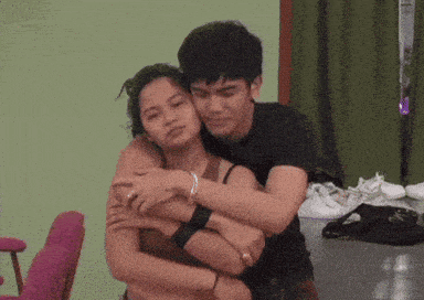 a man and a woman are hugging each other