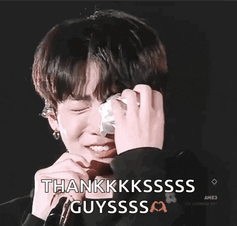 a young man is crying and holding a tissue in his hand .