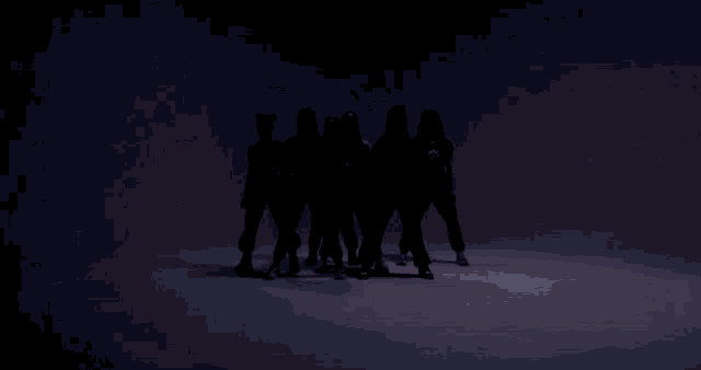 a group of people wearing masks are dancing in a row .