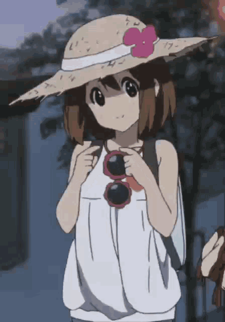 a girl wearing a straw hat and sunglasses holds a backpack