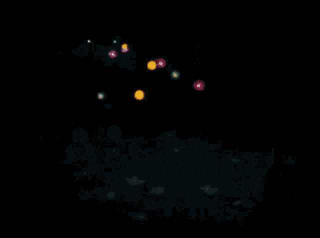 a bunch of flowers are floating in the water at night
