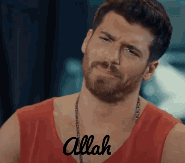 a man with a beard wearing a red tank top with the word allah on his chest
