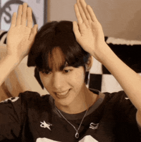 a young man wearing a black shirt with a white star on it