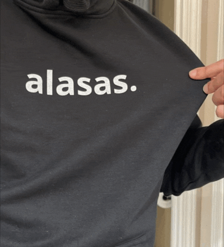a woman is wearing a white shirt that says alasas